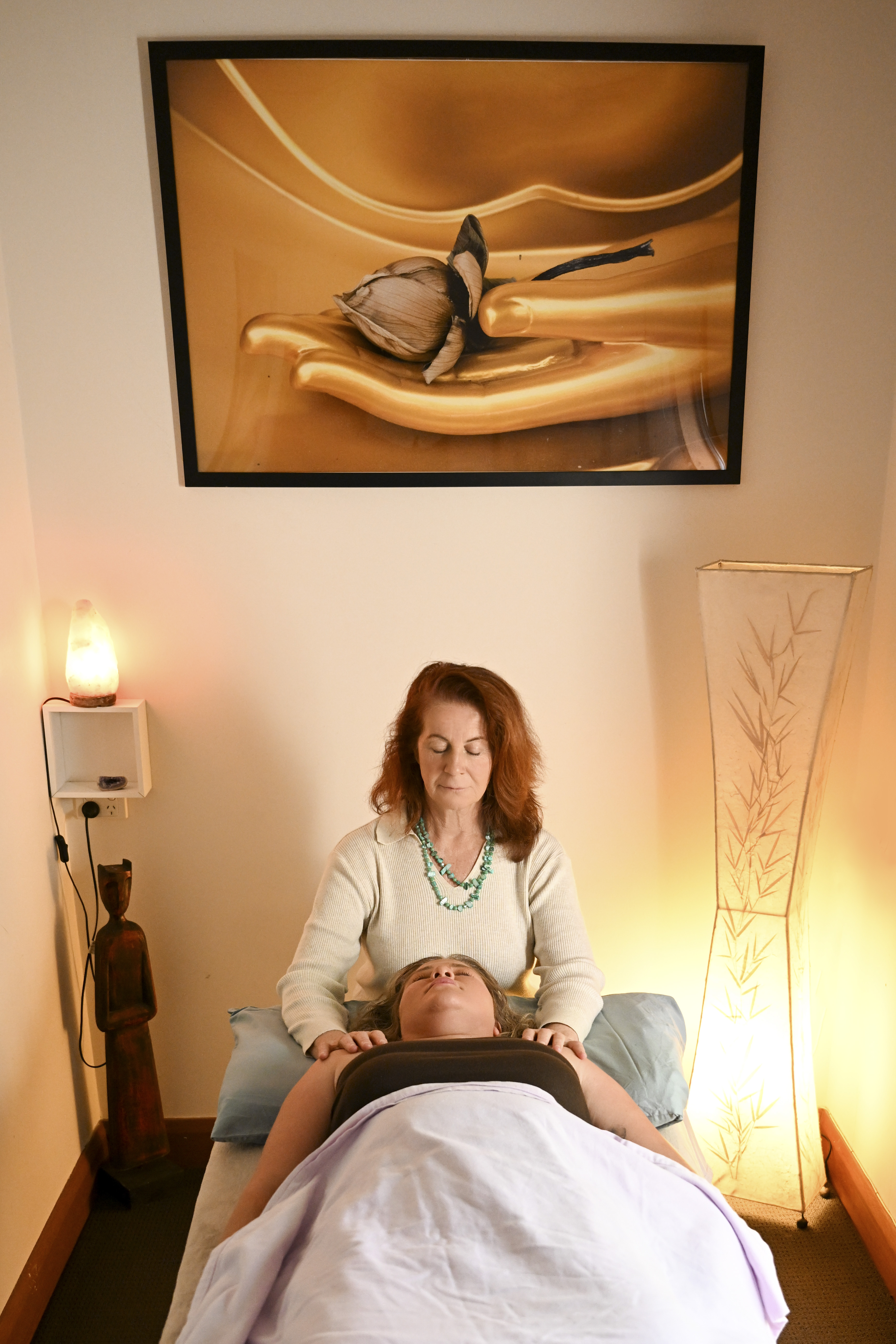 Vicki performing a gentle craniosacral head hold during a treatment session